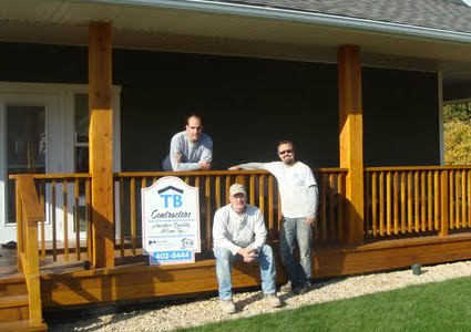 Three men at the front of a house