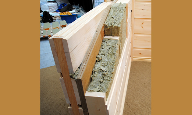 A display wall shows insulation, flat, square logs and fibreboard.
