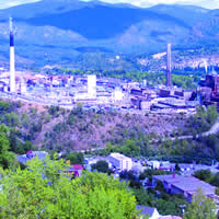 Panoramic view of a sprawling industrial complex in a mountain setting