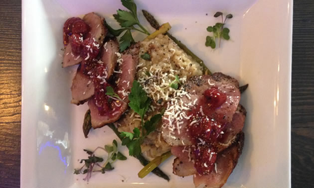 My entree plate shows a duck breast with mushroom risotto, topped with a cherry sauce. 