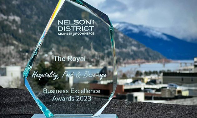 Glass 2023 Business Excellence award, City of Nelson in background of photo. 