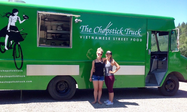 Sydney and Taylor Salvador are standing in front of their Chopsticks Truck. 