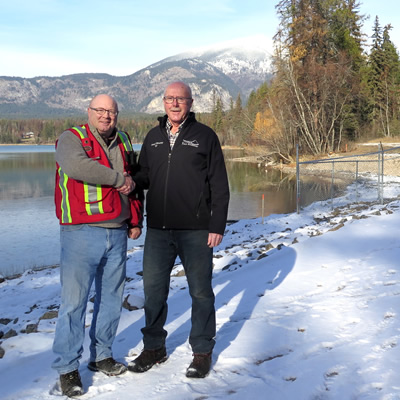 Following a tour of the new dam, RDEK Electoral Area B Director Stan Doehle (right) congratulates project lead Brian De Paoli, RDEK Engineering Technician (left) on the substantial completion of the project.