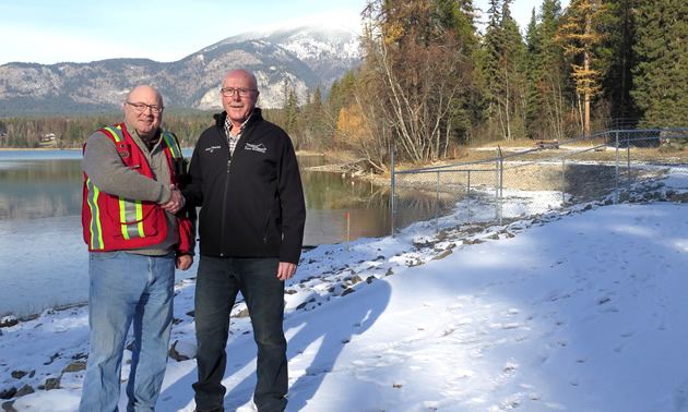 Following a tour of the new dam, RDEK Electoral Area B Director Stan Doehle (right) congratulates project lead Brian De Paoli, RDEK Engineering Technician (left) on the substantial completion of the project.