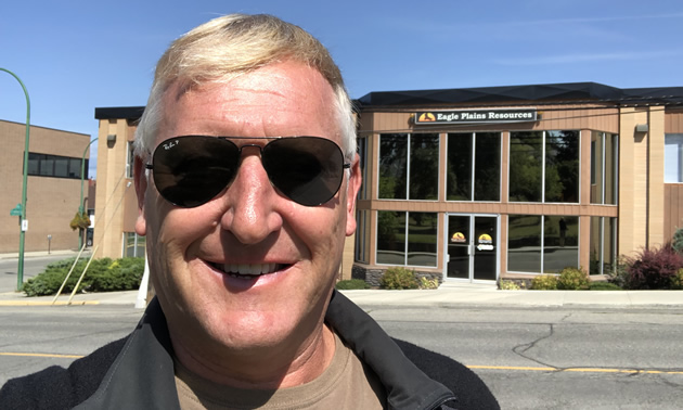 Tim Termuende of Eagle Plains Resources enjoys a sunny moment before heading into his office building