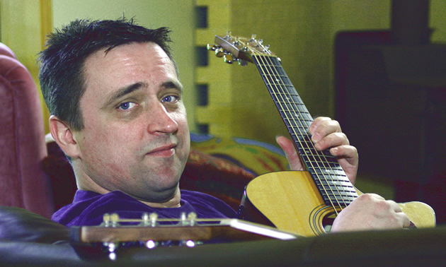 Todd Butler holding his guitar