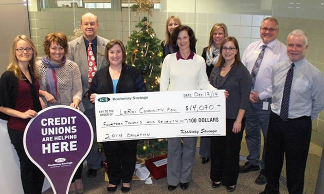 Trail Community Credit Union staff holding large donation cheque