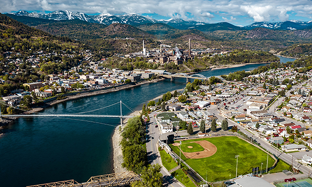 An aerial photo of the city of Trail, showing the bridge over the river in the centre of the city.