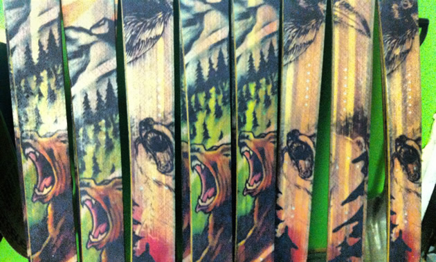 A row of seven boards are covered with graphics of growling bears against mountain backgrounds.