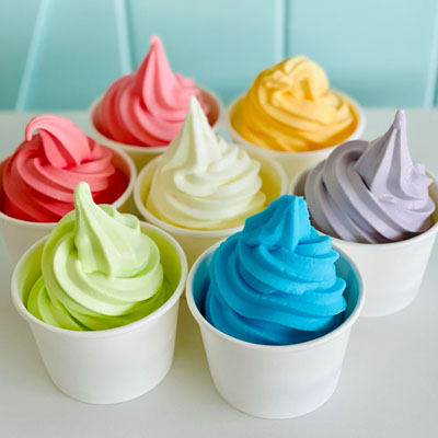 An array of colourful frozen yogurt in cups. 