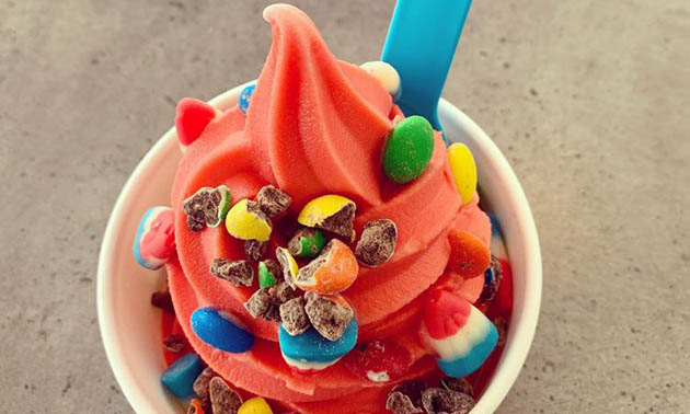 Close-up of frozen yogurt with colourful toppings. 