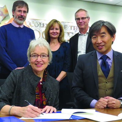 Dr. Catherine Mateer (UVic) and Dr. Stan Chung (College of the Rockies) sign two new partnership agreements as (L-R) deans of instruction Heather Hepworth and Darrell Bethune, director of student affairs Doris Silva and dean of instruction Jack Moes look on.