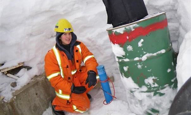 Vanessa Terwoort in orange safety vest, snowy day. 