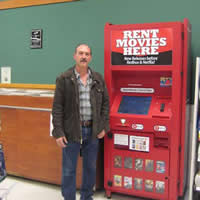 Shane Gilmour stands in front of his new video kiosk