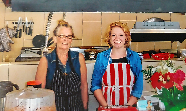 Owners Mari Plamondon and  Alyx Graham-Taylor are standing in front of their restaurant counter, a new location for Wait's on Nelson.