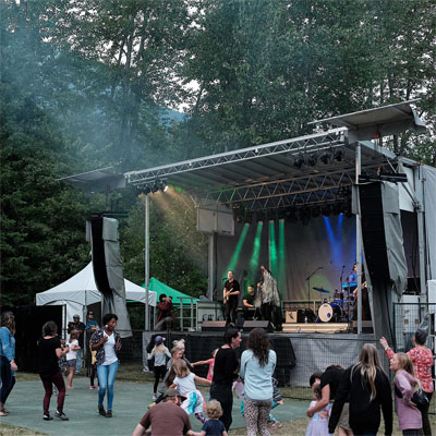 Spectators watch singers and band on stage at Wapiti Music Festival