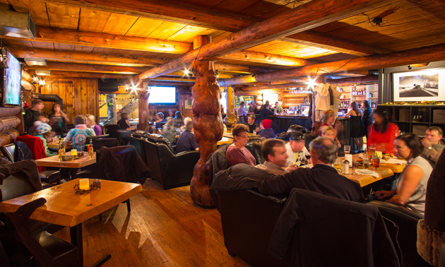 A crowd of diners at Wolf's Den Rustic Mountain Restaurant in Golden, B.C.