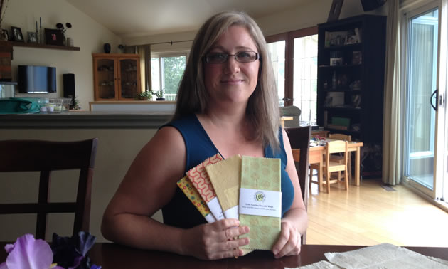 Lana Schanzenbach is holding several of her Little Lunches Reusable Wraps.
