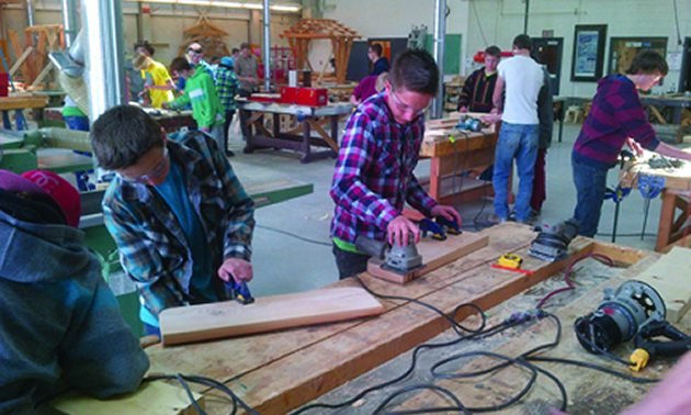 Photo of students practicing their wood and metal-working skills