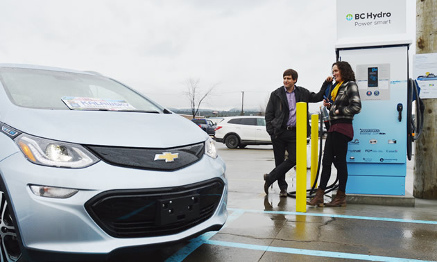 A Chevy Bolt is parked next to the newly unveiled DC fast-charging station in Cranbrook, B.C.