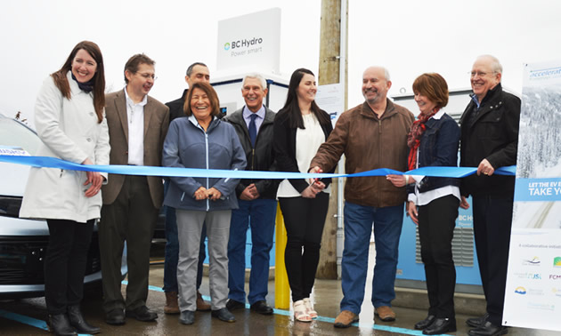 Minister of Energy and Mines and  Kootenay East MLA Bill Bennett is cutting the ribbon for the unveiling of the fast-charging station in a Cranbrook public parking lot.