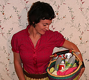 Keri Leeb holding a basket of cleaning supplies