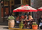 downtown area with people sitting at patio tables