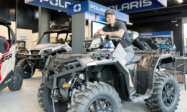 Dayton sitting on a Polaris ATV