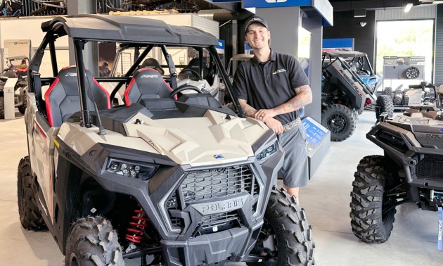 Dayton standing next to a Polaris side-by-side