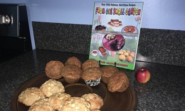 muffins on a plate in front of a cook book