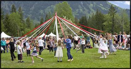 People dancing around a maypole