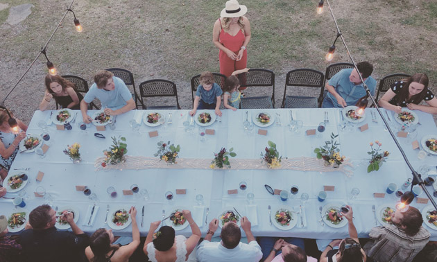 Overhead shot of people dining at a long table. 