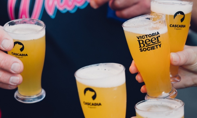 Glasses of beer being held at a beer festival