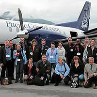 Group of people in front of Pacific Coastal airplane