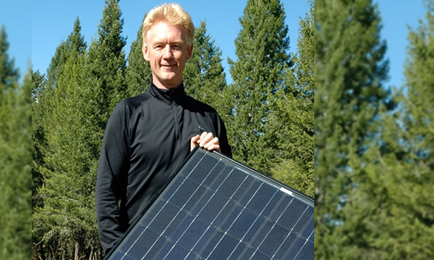 Bill Swan holding a solar panel