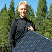 Bill Swan holding a solar panel