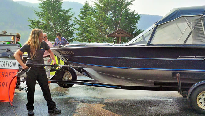 Picture of man showing how to decontaminate a boat with suspected invasive mussels. 