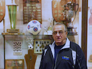 A man standing in front of a trophy case.