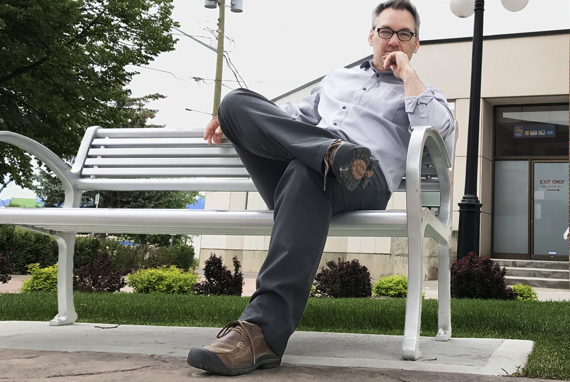 Kerry Shellborn sits on a bench situated beside Cranbrook’s clock tower