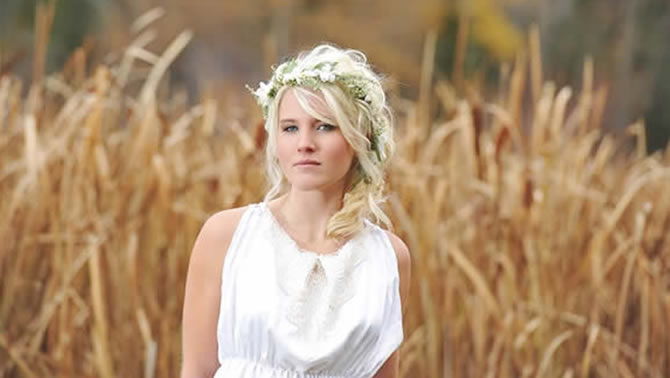 Picture of pretty bride with blonde hair standing in a wheat field