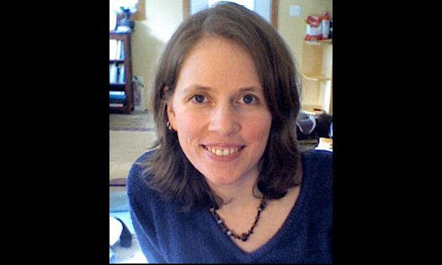 a young-looking woman with brunette hair smiling