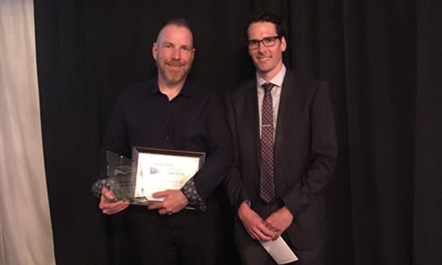 Steve Mercandelli (left), sales manager at Cranbrook Dodge is congratulated on being Cranbrook's Business Person of the Year by Brent Jossy of Scotia Bank and a representative of the Bankers Association of Cranbrook.