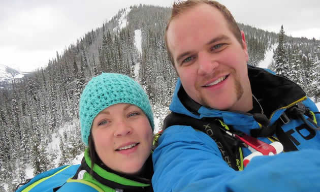 A young man and woman in the backcountry. 