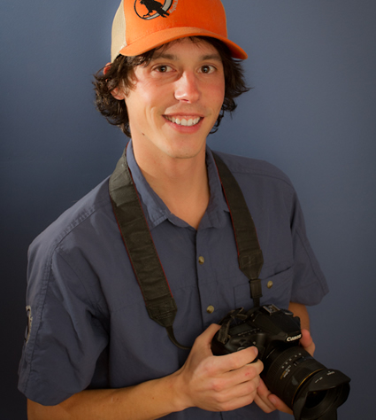 man with a camera wearing a hat