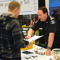 A person looking for a job is interacting with a participant at the College of the Rockies Career and Job Fair 2014. 