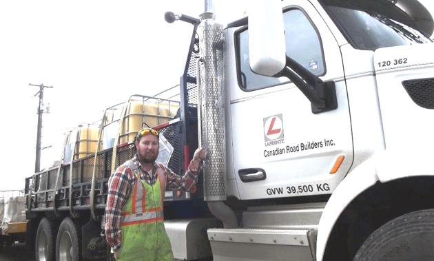 Kyle Procter gets ready to board his 18-wheel Peterbilt 485 to resume working as a road marker  for LaFrentz Road Marking,  a division of Canadian Road Builders Inc. 