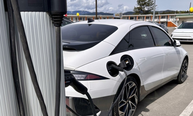 White electric vehicle being charged