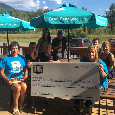 Employees of the Fernie Brewing Company hold up a cheque for the Fernie Friends for Friends. 