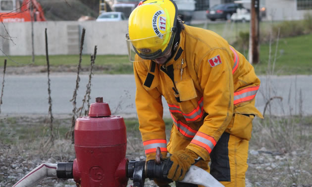 Christina Lake Fire and Rescue crew tap a hydrant.