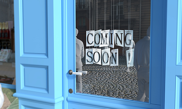 Coming Soon sign on blue door. 